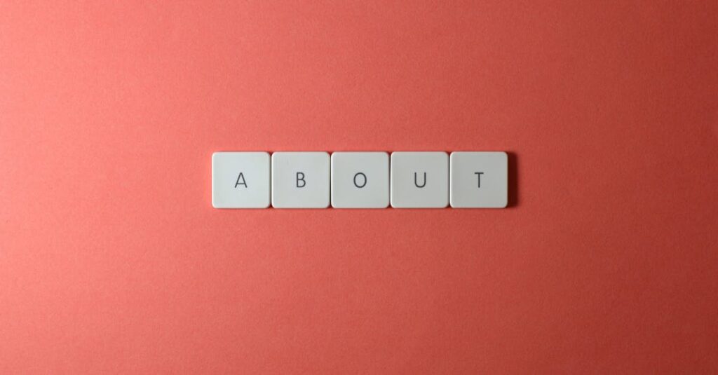 Close-up of keyboard buttons spelling 'ABOUT' against a red surface, minimalist style.