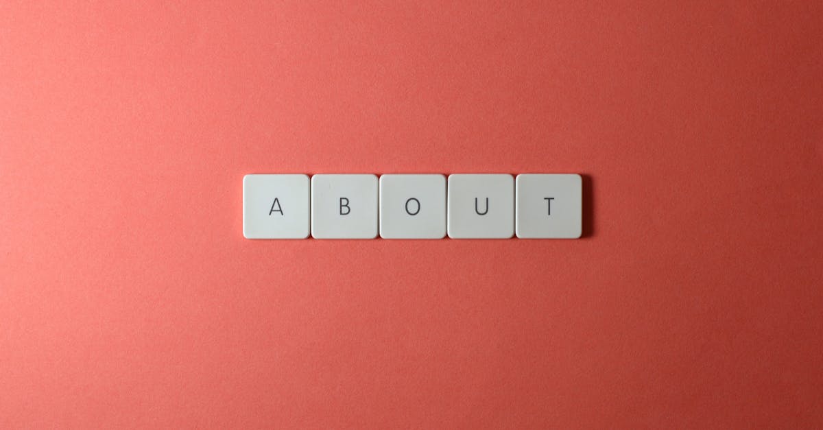 Close-up of keyboard buttons spelling 'ABOUT' against a red surface, minimalist style.